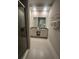 Bathroom showcasing a double vanity with sleek cabinets and a large mirror at 7740 Sandy Ridge Dr # 1, Kissimmee, FL 34744