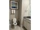 A half bath features a modern vanity, toilet, and decorative artwork at 7740 Sandy Ridge Dr # 1, Kissimmee, FL 34744