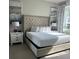 Bedroom featuring a king-size bed with a tufted headboard and coordinated artwork at 7740 Sandy Ridge Dr # 1, Kissimmee, FL 34744