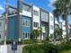 Modern apartment building with blue and grey accents and lush landscaping at 7740 Sandy Ridge Dr # 1, Kissimmee, FL 34744