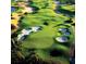 Scenic aerial view of the lush golf course featuring sand traps and meticulously manicured greens at 7740 Sandy Ridge Dr # 1, Kissimmee, FL 34744