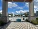Community pool area with lounge chairs and umbrellas, surrounded by modern buildings at 7740 Sandy Ridge Dr # 1, Kissimmee, FL 34744