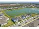 Stunning overhead shot shows homes backing up to a pond and surrounding landscape, near a road at 7793 Clove Hitch Way, Orlando, FL 32832