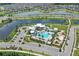 Aerial view of community pool, playground, and lakefront homes on a sunny day at 7793 Clove Hitch Way, Orlando, FL 32832