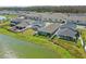 Overhead view showcasing the community homes and picturesque pond with lush green landscaping at 7793 Clove Hitch Way, Orlando, FL 32832