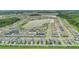 Aerial view of houses in a community situated around a lake with green space on a sunny day at 7793 Clove Hitch Way, Orlando, FL 32832