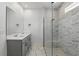 A modern bathroom featuring marble tile in the shower and floors along with a double sink vanity at 7793 Clove Hitch Way, Orlando, FL 32832