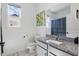 Bright bathroom features a granite countertop vanity, a mirror and a toilet at 7793 Clove Hitch Way, Orlando, FL 32832