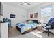 Bright bedroom with neutral carpet, a window, and a colorful bed spread at 7793 Clove Hitch Way, Orlando, FL 32832