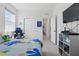 Bright bedroom with neutral carpet, a closet with sliding doors, and a gaming chair at 7793 Clove Hitch Way, Orlando, FL 32832