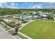 Community pool, playground, and clubhouse with manicured lawn and lush landscaping at 7793 Clove Hitch Way, Orlando, FL 32832