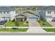 Charming single-story home with brick driveway, gray paint, and view of the lake at 7793 Clove Hitch Way, Orlando, FL 32832