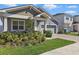 Close up of exterior featuring light gray paint, brick driveway, and manicured lawn at 7793 Clove Hitch Way, Orlando, FL 32832