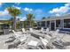 A community fire pit area with Adirondack chairs and palm trees at 7793 Clove Hitch Way, Orlando, FL 32832