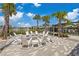 A community fire pit area with Adirondack chairs and palm trees at 7793 Clove Hitch Way, Orlando, FL 32832