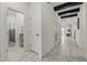 Hallway with marble floors, leading to a bathroom, bedroom, and living room at 7793 Clove Hitch Way, Orlando, FL 32832