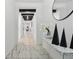 Hallway with white walls, dark beams, marble floors, and a decorative table at 7793 Clove Hitch Way, Orlando, FL 32832