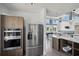 Modern kitchen features stainless steel appliances, ample countertop space, and an open layout at 7793 Clove Hitch Way, Orlando, FL 32832