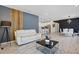 Living area showcasing stylish furnishings, an accent wall, and an open layout connecting to dining and kitchen areas at 7793 Clove Hitch Way, Orlando, FL 32832