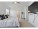 Large bedroom features natural light from two windows, neutral carpet, and ensuite bathroom at 7793 Clove Hitch Way, Orlando, FL 32832