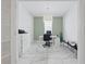 Office with a green accent wall, a desk, rolling chair, and marble floors at 7793 Clove Hitch Way, Orlando, FL 32832