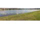 View of a calm pond with grassy banks, offering a peaceful natural setting at 7793 Clove Hitch Way, Orlando, FL 32832