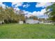 Nice-sized backyard with a lush lawn, storage shed, and mature trees at 790 Park Ln, Kissimmee, FL 34741