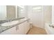 Bathroom with a double-sink vanity, granite countertops, and modern fixtures at 790 Park Ln, Kissimmee, FL 34741