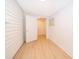 Hallway with wood-look floors leading to a doorway at 790 Park Ln, Kissimmee, FL 34741