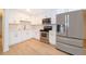 Updated kitchen showcasing stainless steel appliances and white cabinetry at 790 Park Ln, Kissimmee, FL 34741
