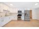 Bright kitchen features white cabinetry, stainless steel appliances, and updated finishes at 790 Park Ln, Kissimmee, FL 34741