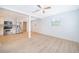 A bright living room is shown, with a ceiling fan, white walls, and wood-look floors at 790 Park Ln, Kissimmee, FL 34741