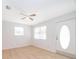Bright living room showcasing the front door, windows, and wood-look floors at 790 Park Ln, Kissimmee, FL 34741
