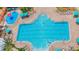 Aerial view of a resort-style pool with umbrellas, pool furniture and multiple swimmers at 8204 Fan Palm Way, Kissimmee, FL 34747