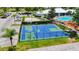 Aerial shot of the community basketball court with fencing, manicured landscaping, and parking at 8204 Fan Palm Way, Kissimmee, FL 34747