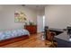 A comfortable bedroom with hardwood floors and a spacious layout for a desk and chair at 8204 Fan Palm Way, Kissimmee, FL 34747