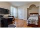 Cozy bedroom with hardwood floors, a double door closet, and a large window at 8204 Fan Palm Way, Kissimmee, FL 34747