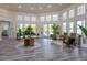 Interior of community clubhouse with plants, seating, and large windows at 8204 Fan Palm Way, Kissimmee, FL 34747