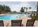 Community pool with comfortable chaise lounge chairs, umbrellas and white gazebo at 8204 Fan Palm Way, Kissimmee, FL 34747