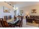 Formal dining room and open living area featuring neutral paint, tile flooring and lots of natural light at 8204 Fan Palm Way, Kissimmee, FL 34747