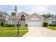Inviting single-Gathering home with an attached two-car garage and well-maintained lawn at 8204 Fan Palm Way, Kissimmee, FL 34747