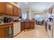 Well-lit kitchen featuring granite countertops, wood cabinets, and a charming breakfast nook at 8204 Fan Palm Way, Kissimmee, FL 34747