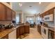 Spacious kitchen with warm wood cabinetry, granite countertops and a cozy breakfast area with lots of light at 8204 Fan Palm Way, Kissimmee, FL 34747