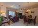 An open-concept living room and dining room with tile flooring and ample natural light at 8204 Fan Palm Way, Kissimmee, FL 34747