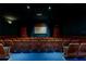 An interior of a community movie theater with large screen, projector, and individual seating at 8204 Fan Palm Way, Kissimmee, FL 34747
