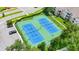 Aerial view of the community tennis courts, featuring blue courts, green space, and parking at 8204 Fan Palm Way, Kissimmee, FL 34747