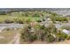 Aerial view of a home near a lush golf course and a well-trafficked road at 10538 Clarcona Ocoee Rd, Apopka, FL 32703