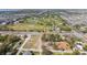 Aerial view of home by golf course, highway, and future construction site at 10538 Clarcona Ocoee Rd, Apopka, FL 32703