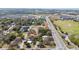Aerial view of home near golf course, highway, and a construction area at 10538 Clarcona Ocoee Rd, Apopka, FL 32703