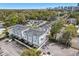 Aerial view of townhome community surrounded by lush greenery and city skyline at 117 E Concord St # 8, Orlando, FL 32801